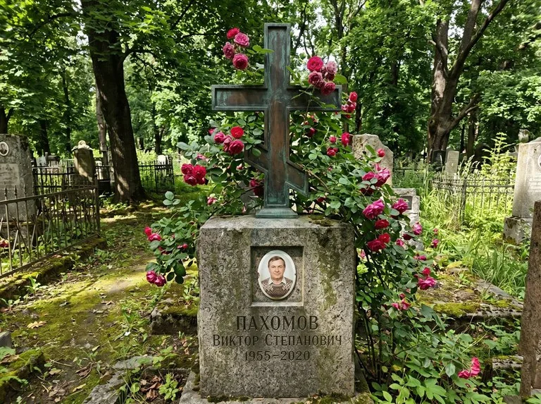 Бронзовый крест с розами на гранитной плите в Салехарде